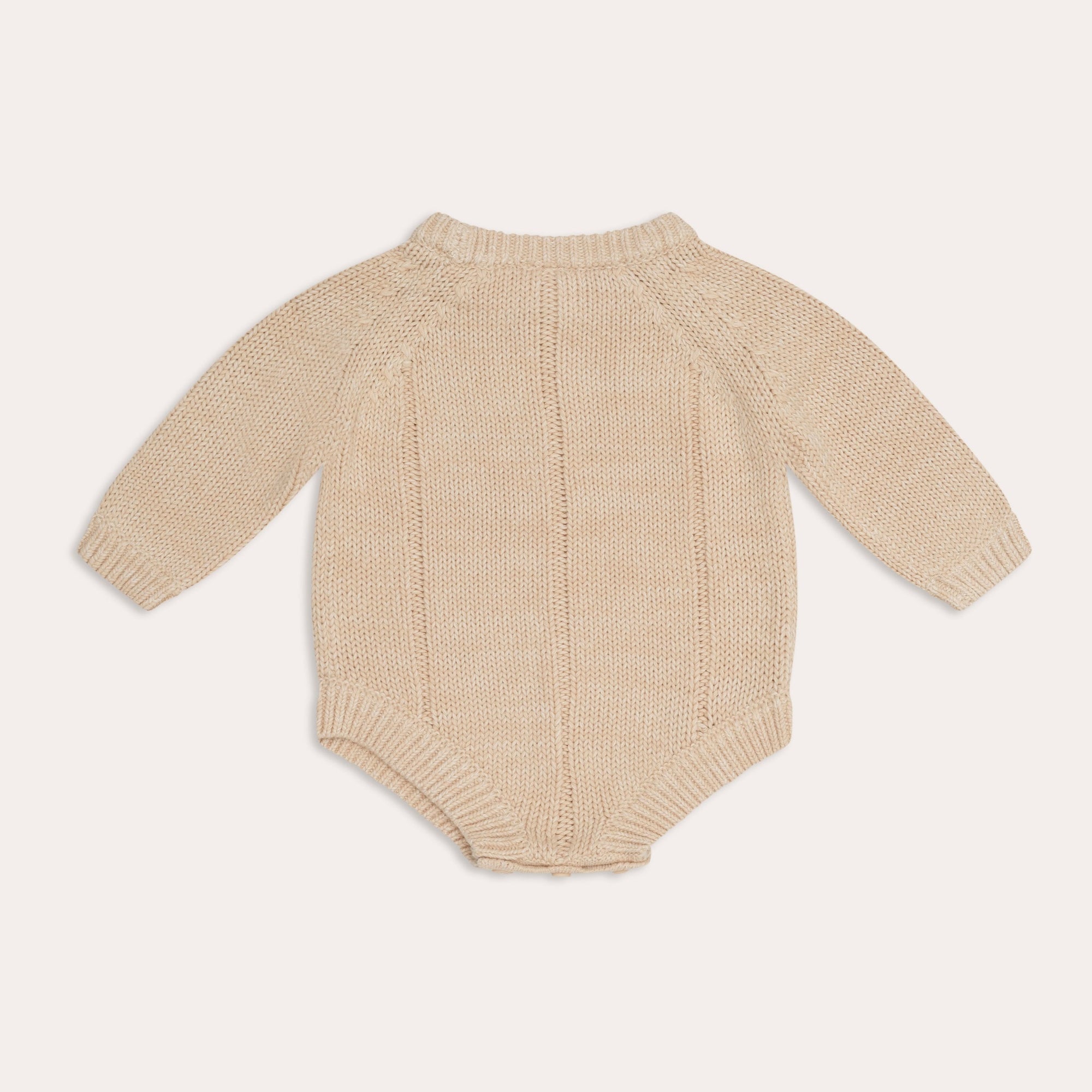 An Illoura the Label baby's illoura tallow knit romper in sand.