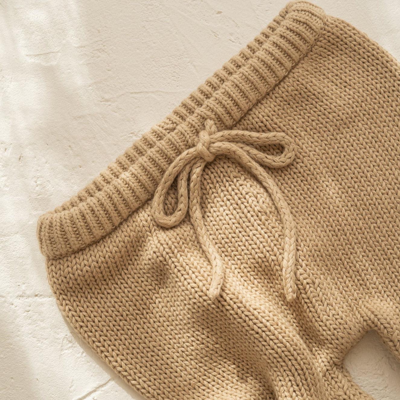 A pair of Illoura the Label's illoura poet pants in olive on a white surface.