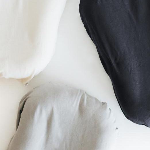 Three Snuggle Me Lounger Cover on a white surface.