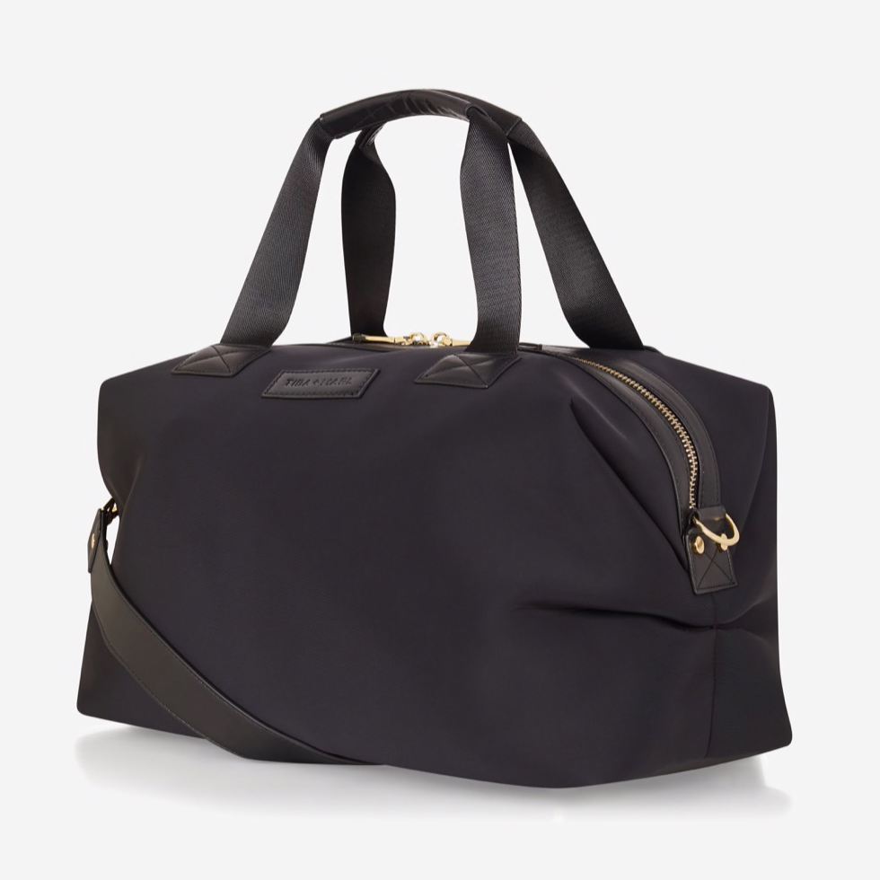 A sleek and compact every-day version of our best selling RAF WEEKENDER. Smaller but perfectly formed and includes all original internal functionality.   This hard-working holdall gets a sports-lux make-over in sleek Black scuba fabric, paired with lux gold hardware. The perfect size to fit all your essential items for a day out, it also doubles up as a stylish work bag, hand bag or overnight bag.