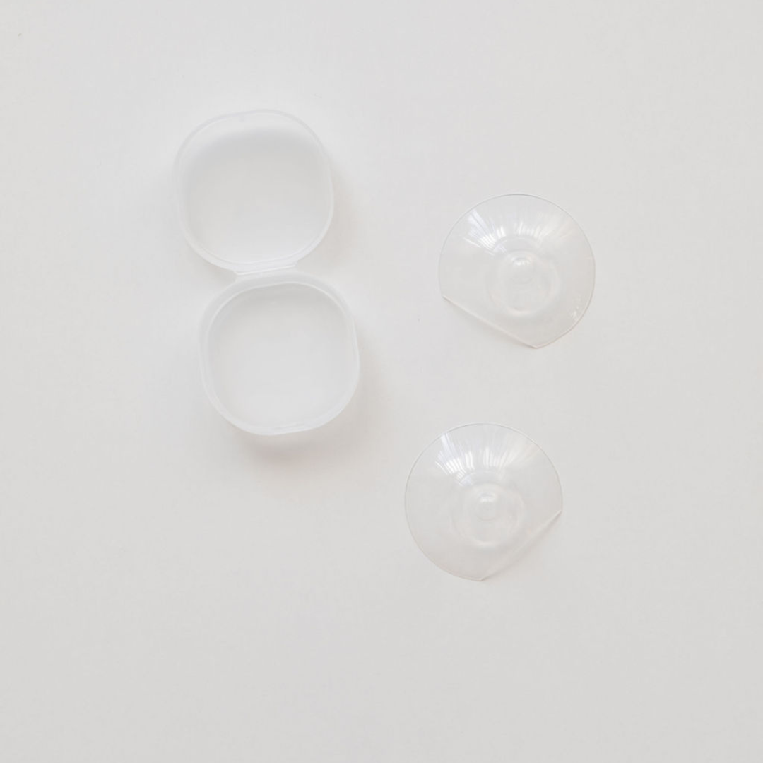 A pair of Haakaa Silicone Nipple Shields on a white surface.