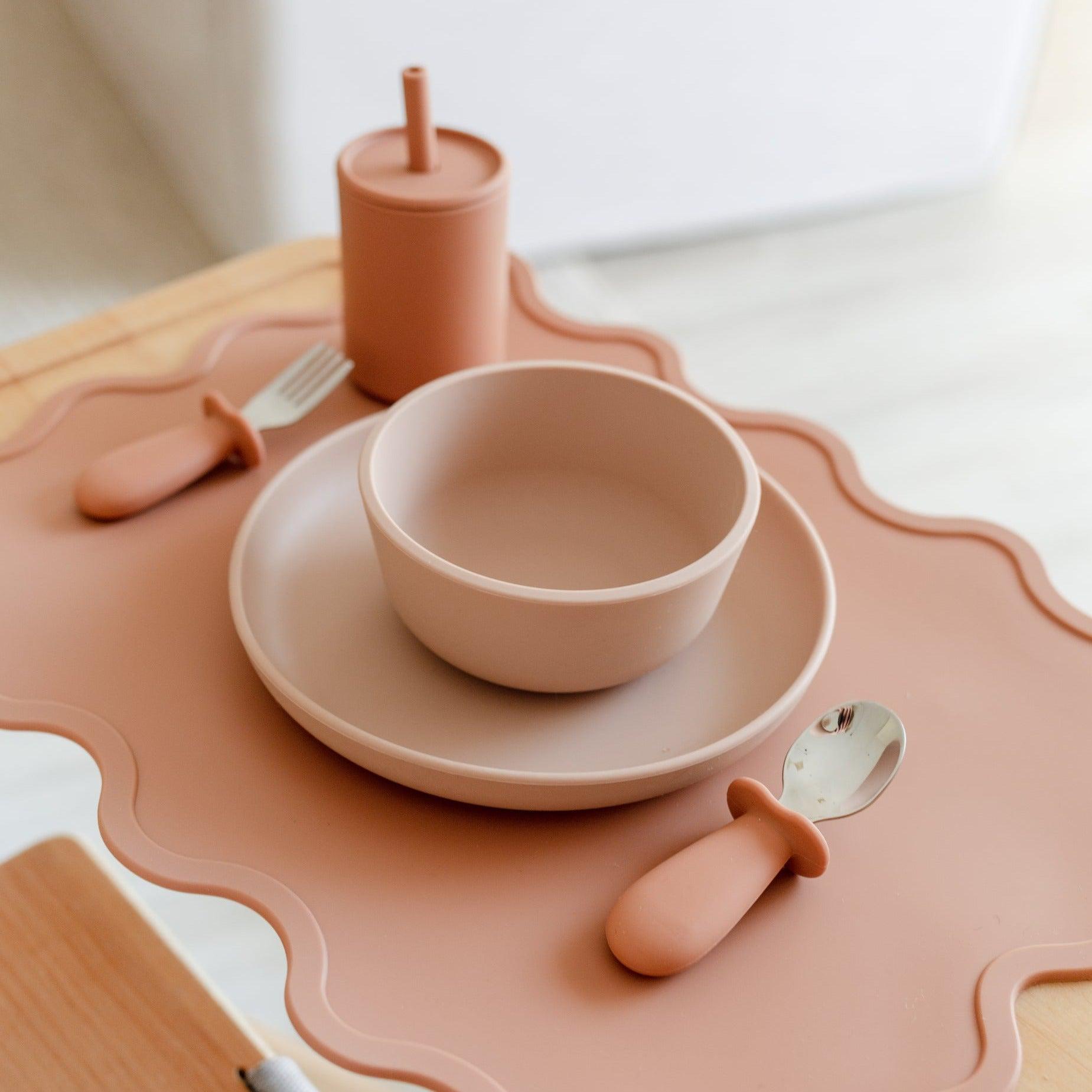 Encourage independence and mealtime with a Rommer toddler cutlery set in cinnamon on a table, perfect for curious little hands.
